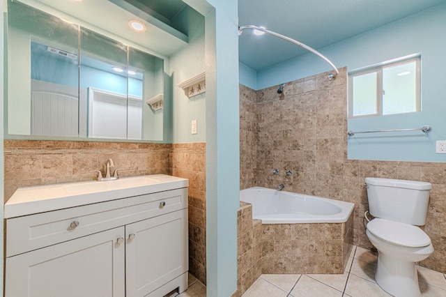 full bathroom with tile walls, vanity, tile patterned floors, and toilet