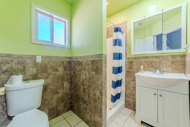 bathroom featuring curtained shower, tile patterned flooring, tile walls, toilet, and vanity