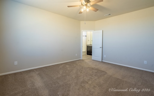 spare room featuring light carpet and ceiling fan