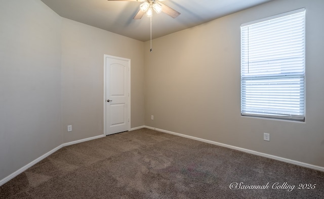 carpeted spare room with ceiling fan