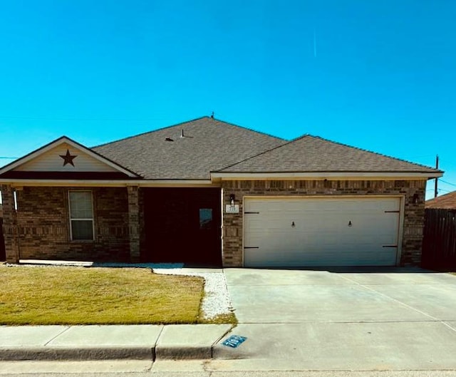 ranch-style house with a front yard and a garage