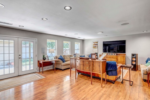 living area with french doors, light wood finished floors, recessed lighting, visible vents, and baseboards