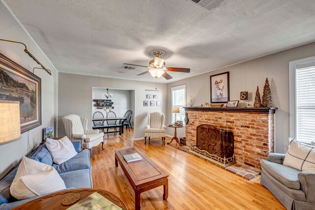 living room with a healthy amount of sunlight, visible vents, and wood finished floors