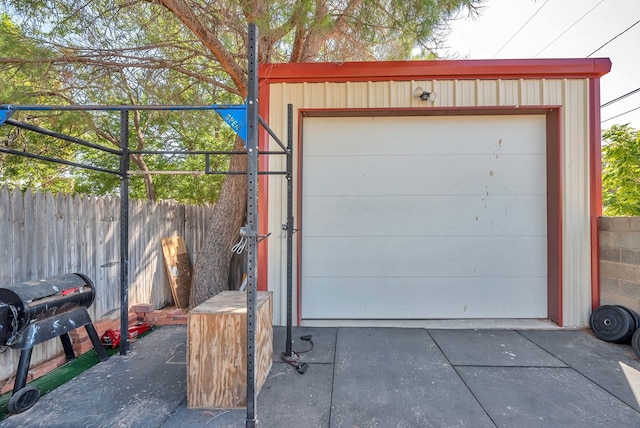 detached garage with driveway and fence