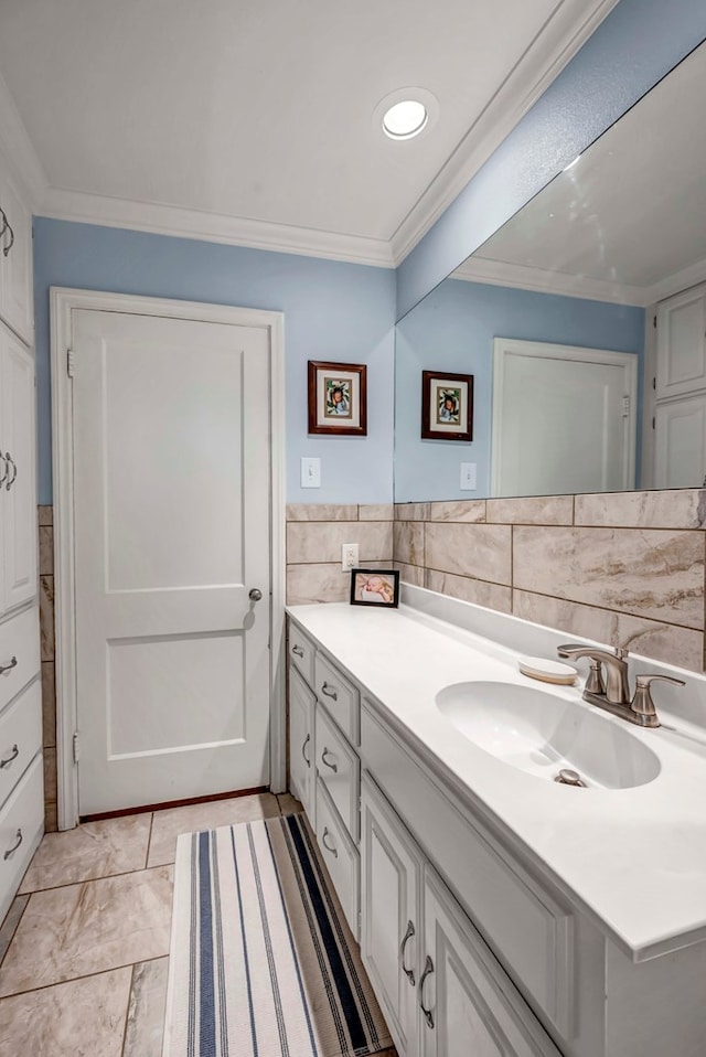 bathroom featuring crown molding, tile walls, and vanity