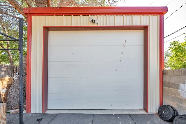 detached garage featuring fence