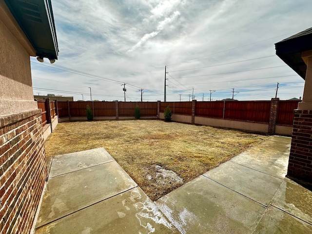 view of yard with a fenced backyard and a patio area