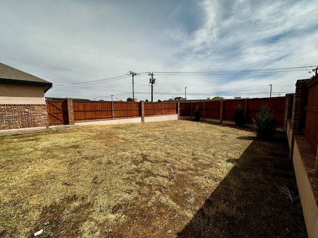 view of yard with a fenced backyard