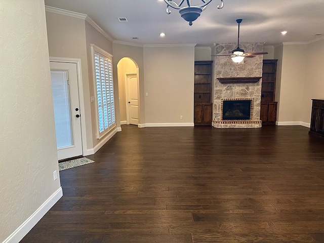 unfurnished living room featuring a ceiling fan, arched walkways, dark wood-style flooring, and ornamental molding