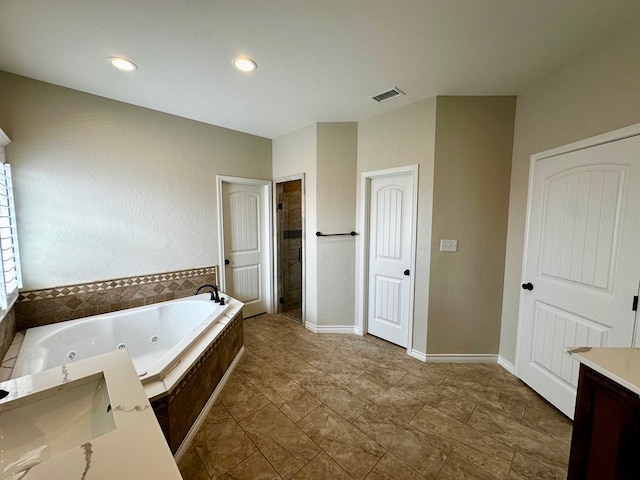 full bath with vanity, baseboards, visible vents, a whirlpool tub, and a shower stall