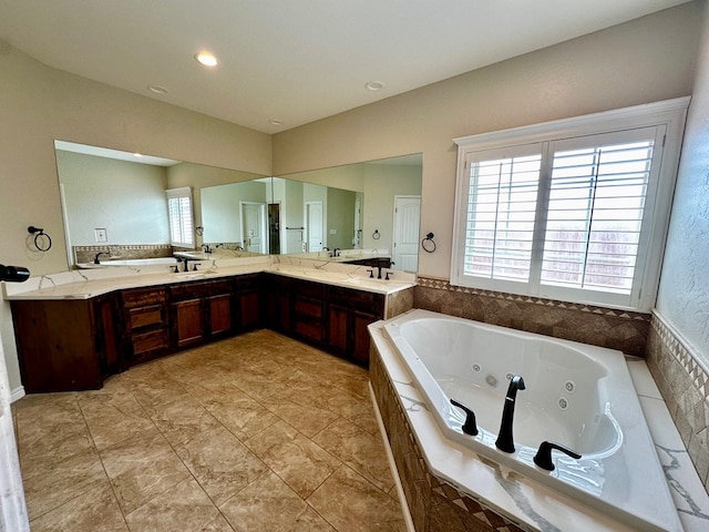 full bath with double vanity and a whirlpool tub