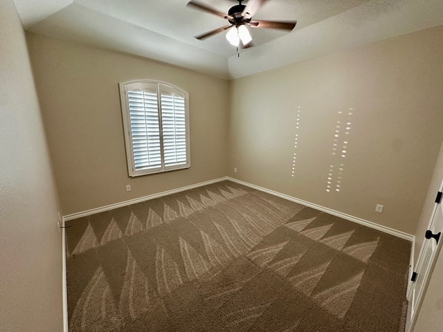 carpeted spare room with baseboards, lofted ceiling, and a ceiling fan