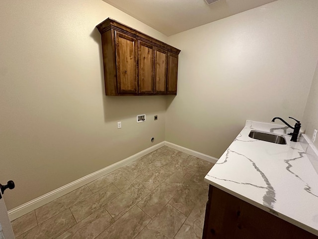 washroom with a sink, cabinet space, baseboards, hookup for an electric dryer, and hookup for a washing machine