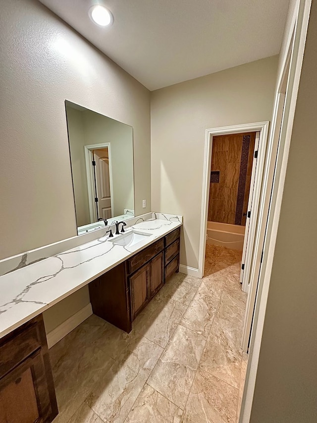 full bath with bathtub / shower combination, vanity, and baseboards