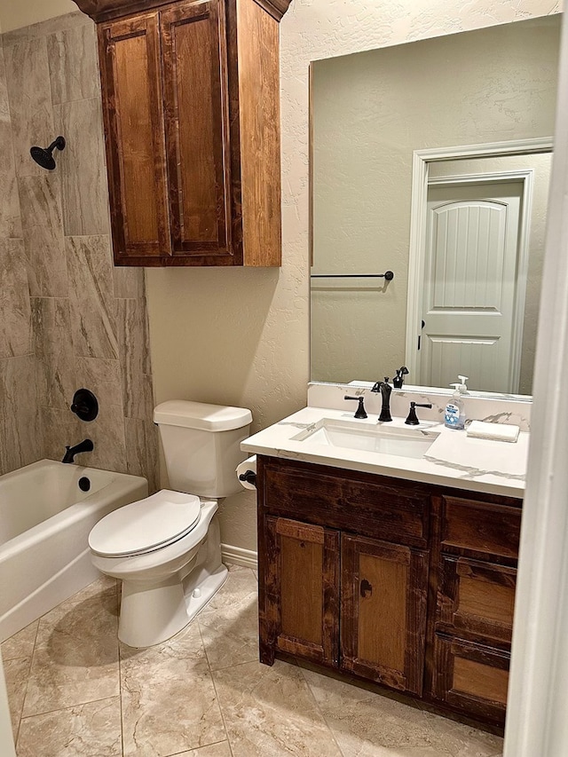 full bathroom with vanity, baseboards, shower / tub combination, toilet, and a textured wall