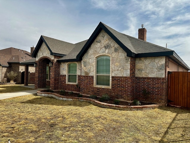 view of property exterior featuring brick siding, stone siding, and a chimney