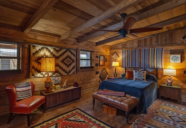 bedroom featuring beamed ceiling, wood-type flooring, and wood walls