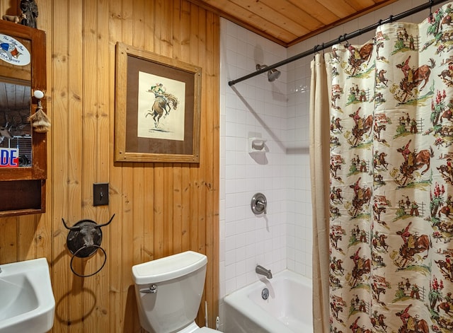 bathroom with wood walls, sink, wooden ceiling, and toilet