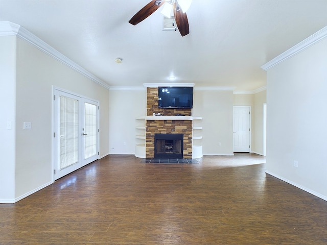 unfurnished living room with baseboards, a ceiling fan, dark wood-style floors, crown molding, and a stone fireplace