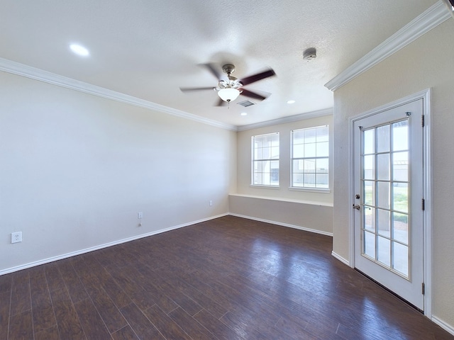 empty room featuring baseboards, visible vents, ornamental molding, and dark wood finished floors