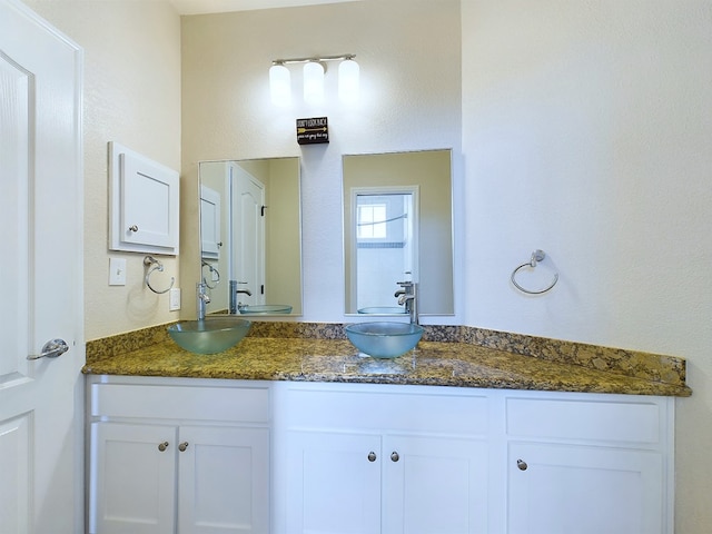 bathroom with double vanity and a sink