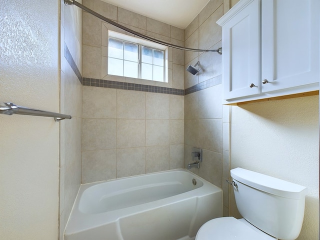 full bathroom with bathtub / shower combination, a textured wall, and toilet