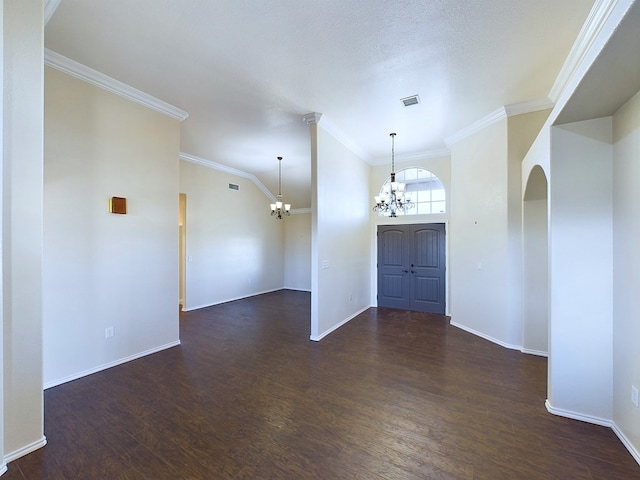 foyer with a chandelier, dark wood-type flooring, and baseboards