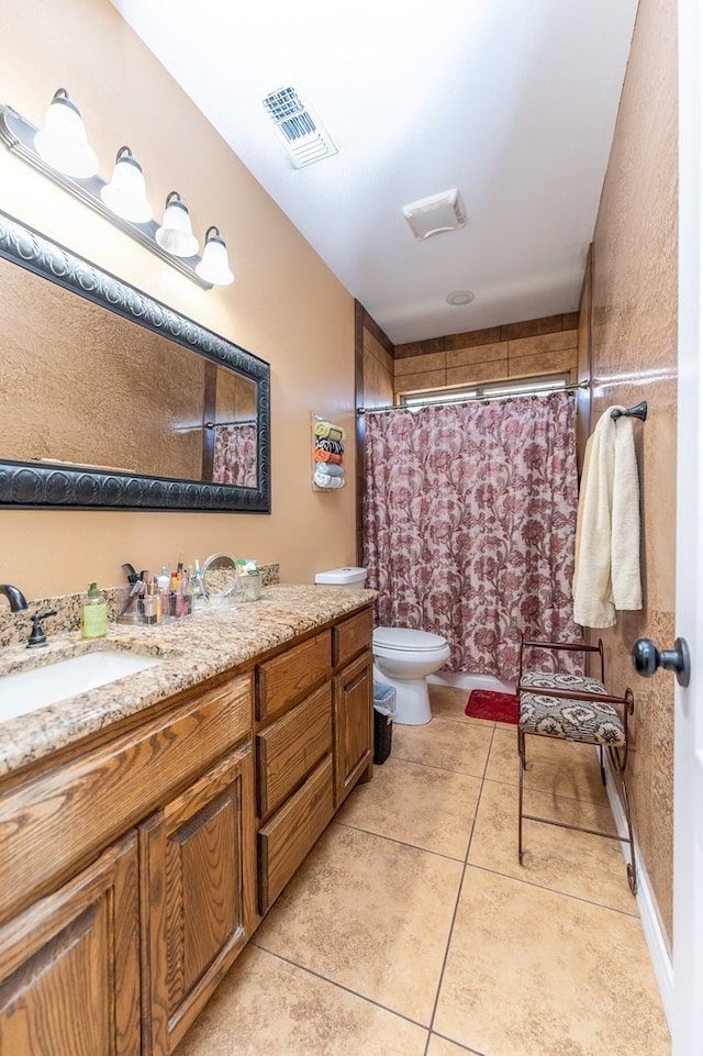 bathroom featuring tile patterned floors, vanity, and toilet