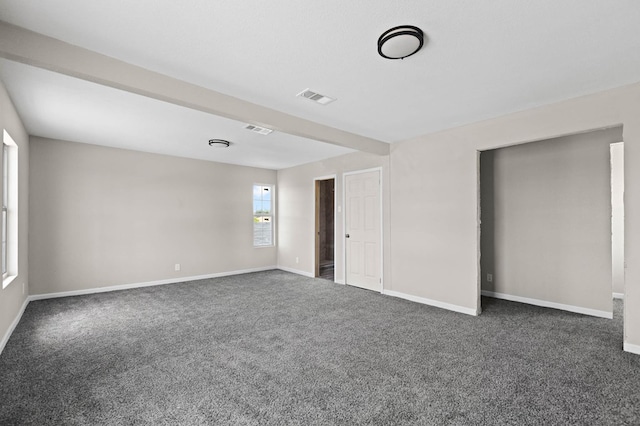 spare room with visible vents, carpet floors, and baseboards