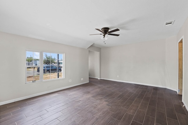 empty room with visible vents, baseboards, ceiling fan, and wood tiled floor