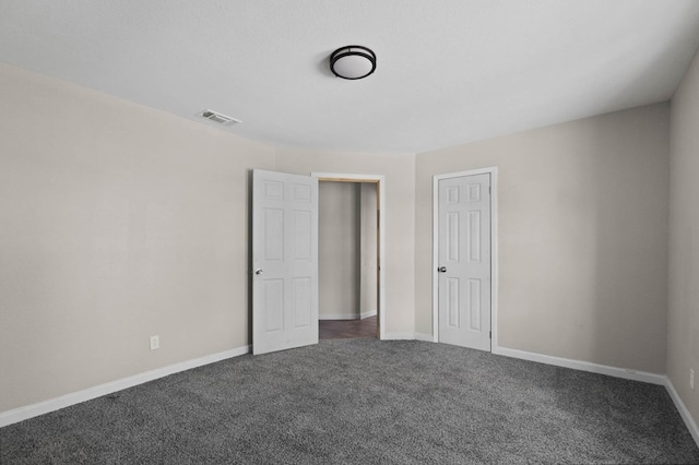 unfurnished bedroom featuring visible vents, baseboards, and carpet floors