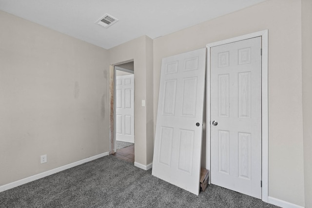 unfurnished bedroom with visible vents, carpet, and baseboards