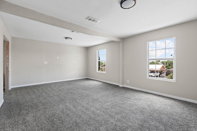 carpeted spare room with baseboards and visible vents