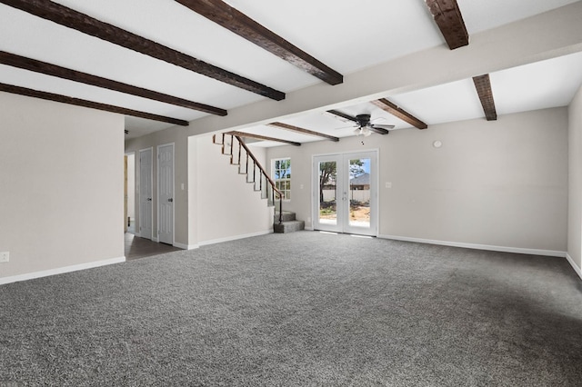 unfurnished living room with stairway, baseboards, ceiling fan, and dark carpet