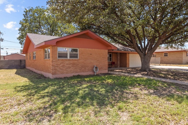 single story home with a garage and a front lawn