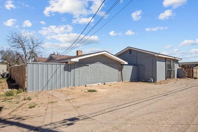 view of home's exterior featuring fence