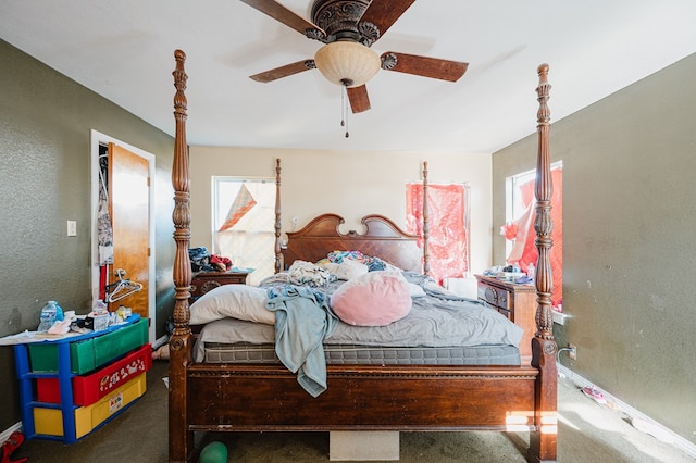 bedroom featuring ceiling fan and dark colored carpet