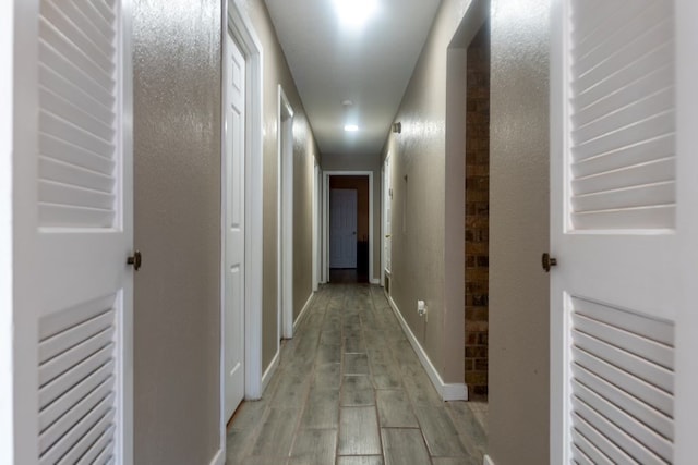 hall with light hardwood / wood-style flooring