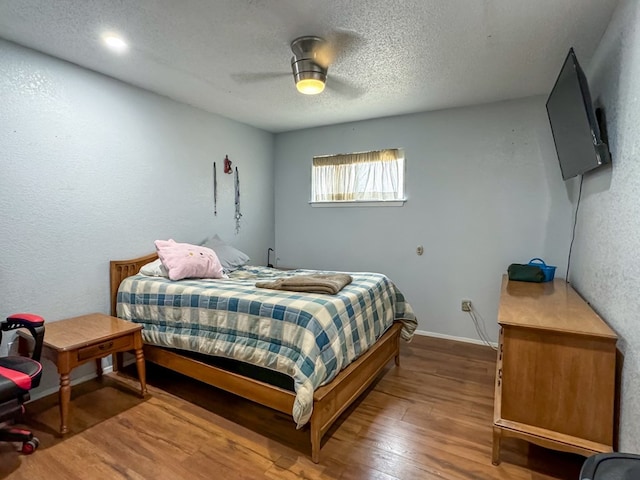 bedroom featuring a textured ceiling, hardwood / wood-style flooring, and ceiling fan