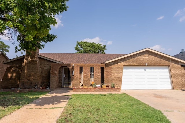 ranch-style house featuring a front yard and a garage