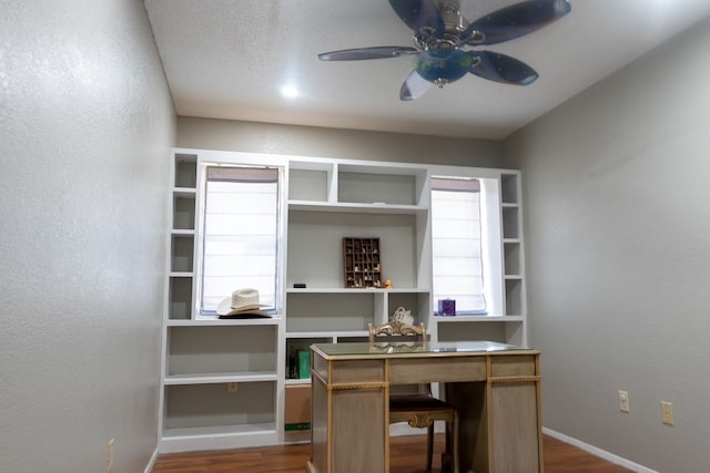 office featuring ceiling fan, dark wood-type flooring, and a textured ceiling