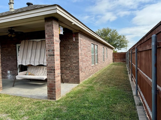 view of home's exterior with a lawn and a patio