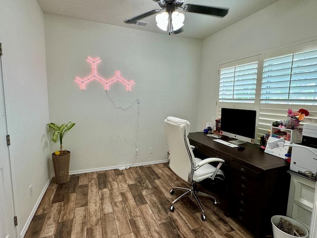 office with dark hardwood / wood-style floors and ceiling fan