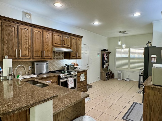 kitchen featuring stainless steel electric stove, sink, hanging light fixtures, dark stone countertops, and ornamental molding