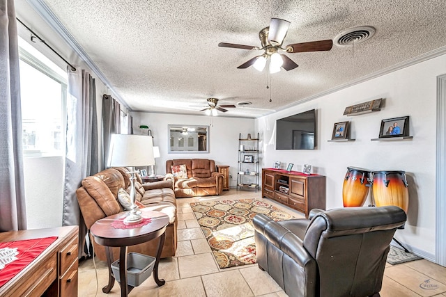 living room with ornamental molding, ceiling fan, and a textured ceiling