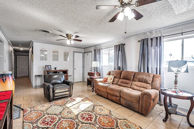 living room featuring ornamental molding, ceiling fan, and a textured ceiling