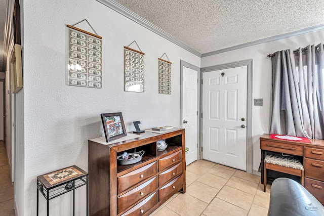 tiled foyer with ornamental molding and a textured ceiling