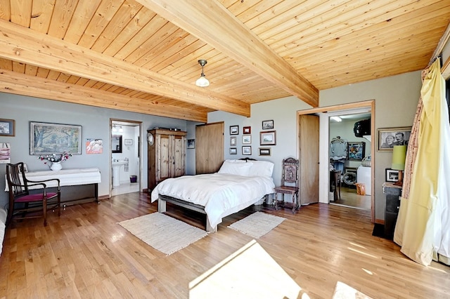 bedroom featuring beam ceiling, light wood-type flooring, ensuite bath, and wood ceiling