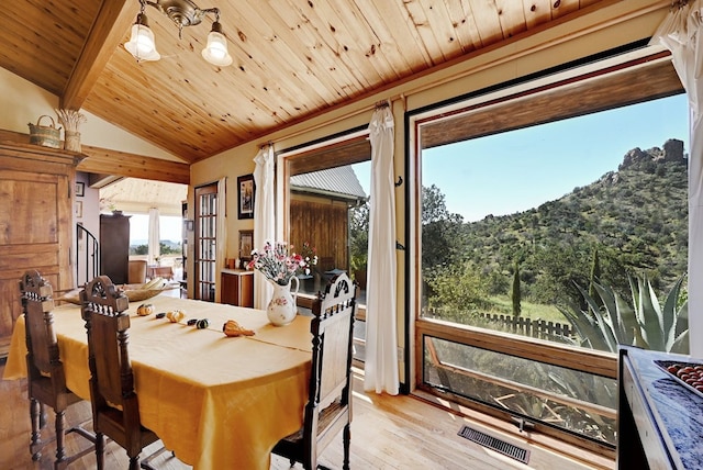 dining area featuring vaulted ceiling with beams, french doors, wood ceiling, and light wood-type flooring