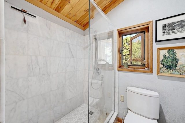 bathroom with tiled shower, lofted ceiling, toilet, and wooden ceiling